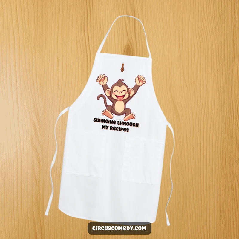Funny apron graphic of a grinning monkey swinging from a trapeze, adding a touch of jungle fun to cooking.