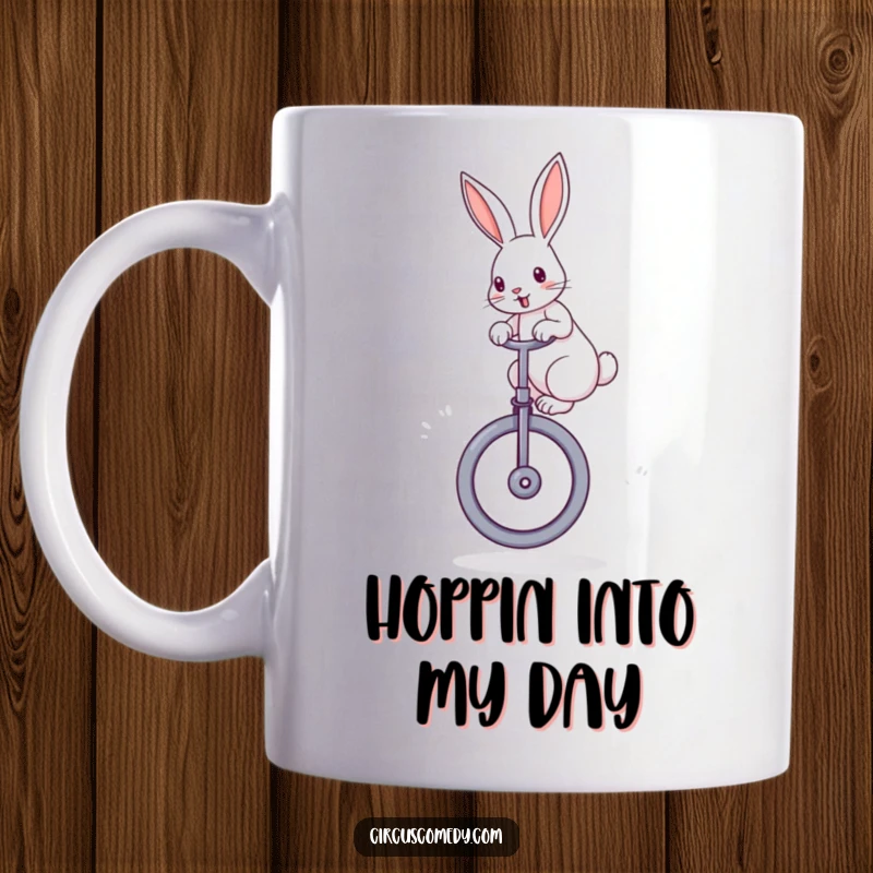 Funny rabbit mug featuring a determined rabbit with perked ears, skillfully balancing on a large unicycle against a fun background.