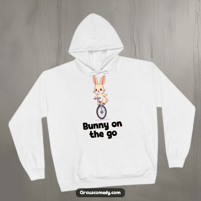 Funny rabbit hoodie featuring a determined rabbit balancing on a large unicycle with perked ears, perfect for chilly days.
