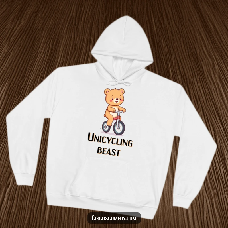 Funny hoodie depicting a happy bear skillfully balancing on a unicycle, exuding joy and playful spirit.