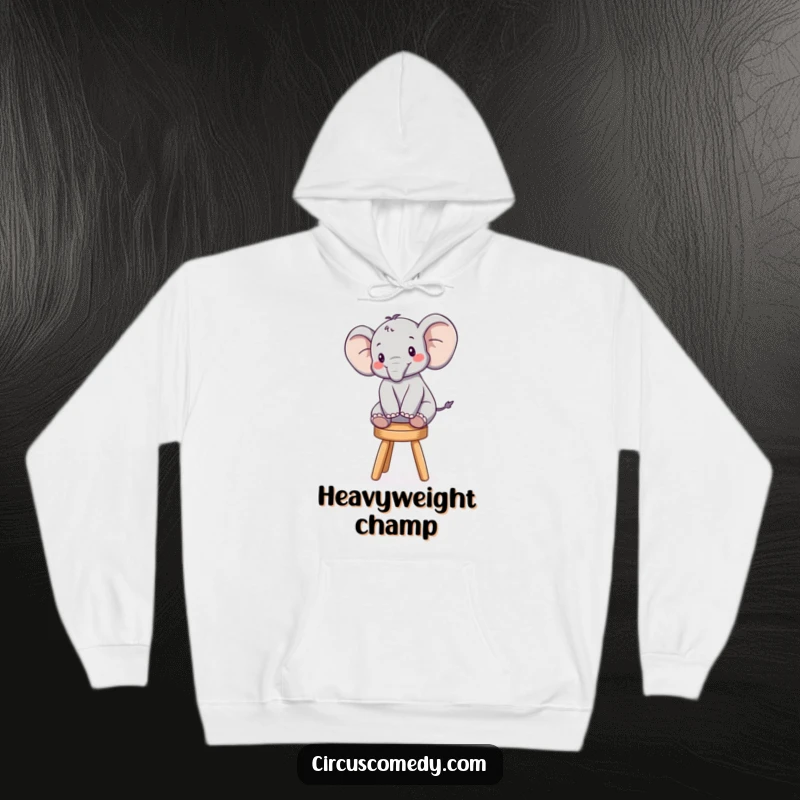 Funny hoodie depicting a cheerful elephant executing a precarious balancing act on a miniature stool, exuding playful charm.