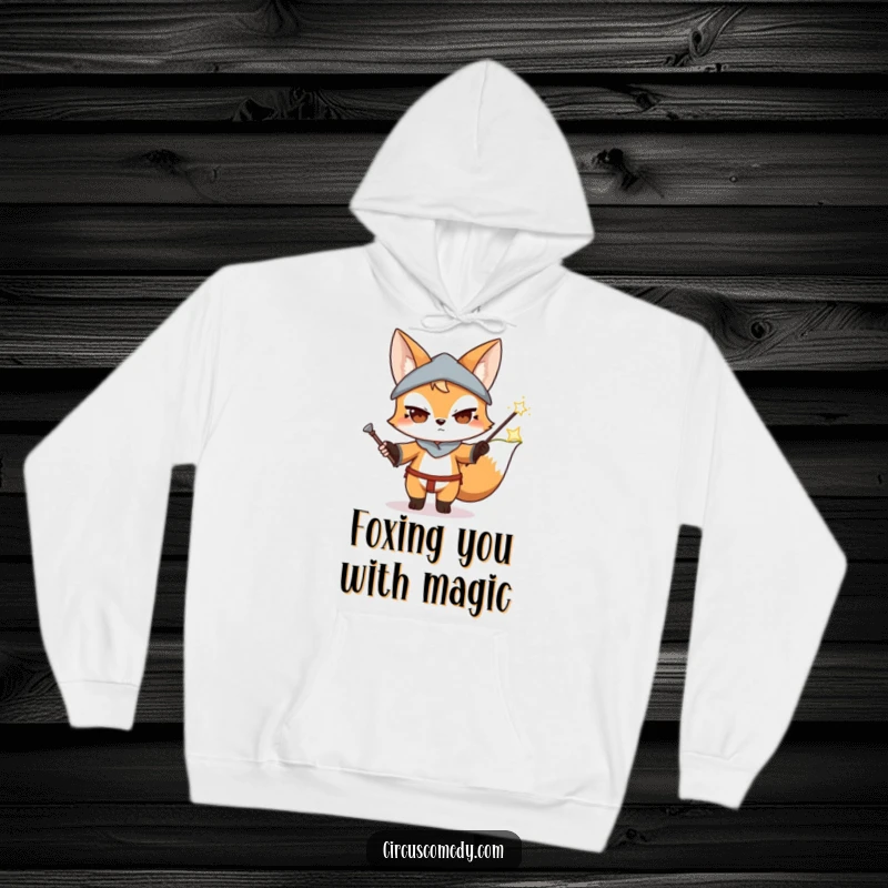 Funny Fox Magician Hoodie: A warm hoodie depicting a determined fox performing a magic trick with a wand, conjuring mysterious effects.