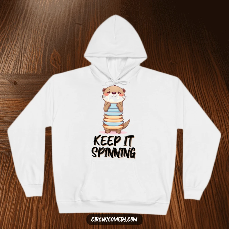 Funny otter balancing a precarious stack of plates, on a soft hoodie, a warm and humorous item.