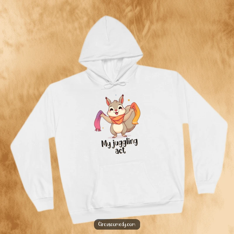 Funny hoodie depicting a happy squirrel performing a colorful scarf juggling act, perfect for staying warm with a touch of playful style.
