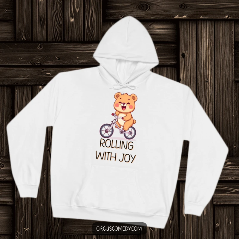 Funny bear with a wide smile riding a unicycle, featured on a cozy hoodie, a warm and humorous item.