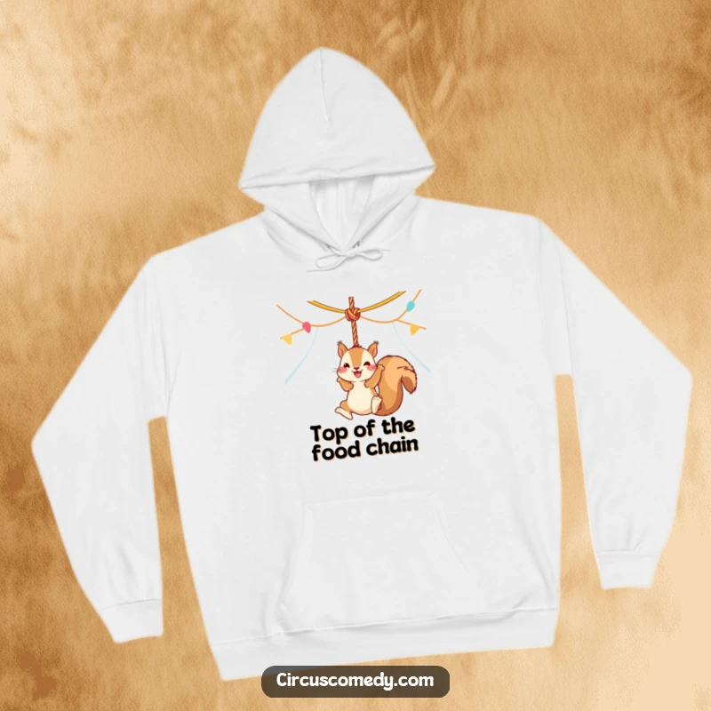 Funny squirrel in a vibrant circus tent, joyfully swinging from a rope, depicted on a comfortable and humorous hoodie.