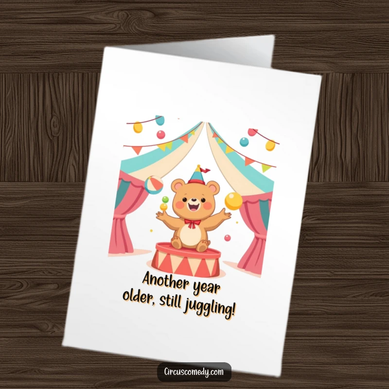 Funny Free Printable Birthday Card: Happy bear juggling colorful balls in a circus tent, exuding joy.