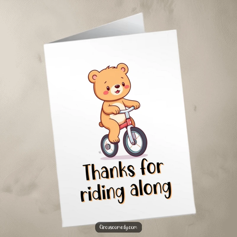 Funny free printable thank you card: A joyful bear wobbling slightly while riding a unicycle, conveying warm thanks.