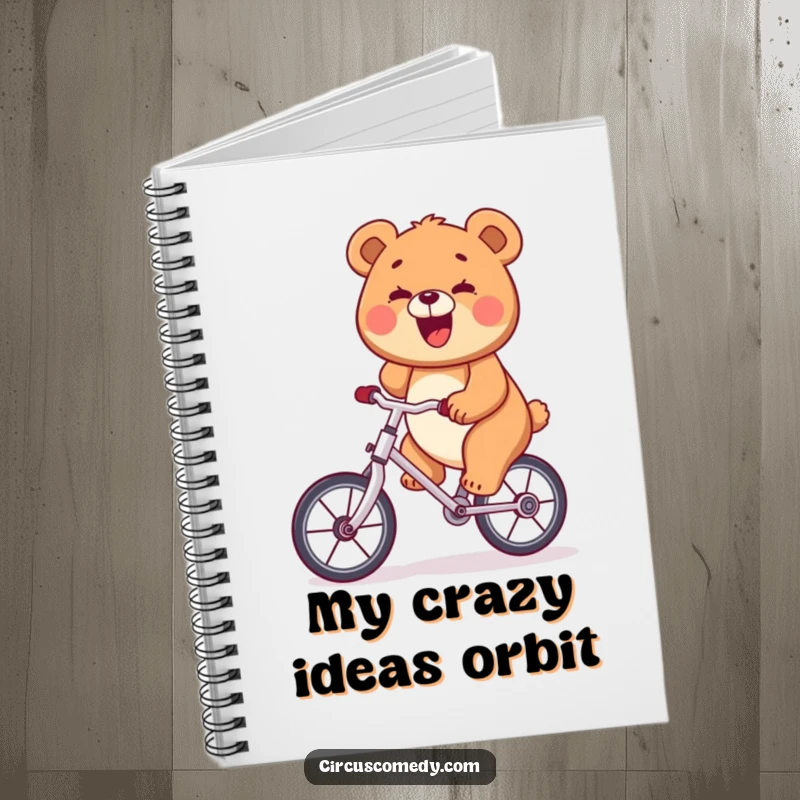 Funny bear riding a unicycle with a wide smile on a notebook cover, inspiring balanced thoughts.