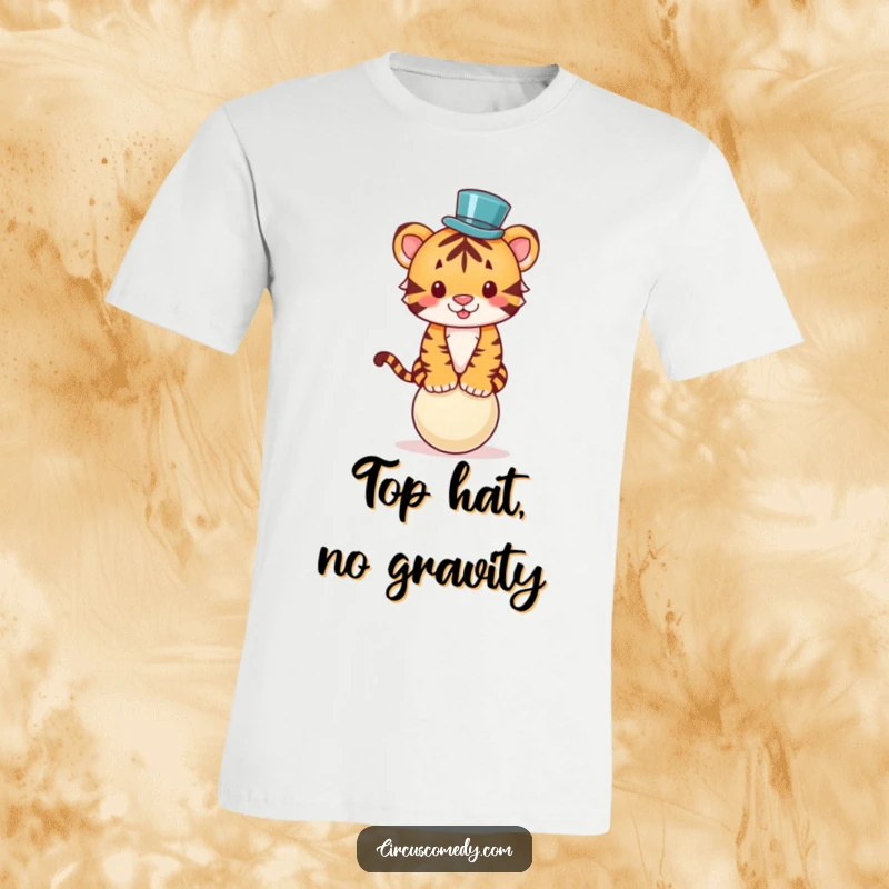 Funny t-shirt with a cute tiger wearing a tiny top hat, balancing precariously on a ball with circus-like flair.