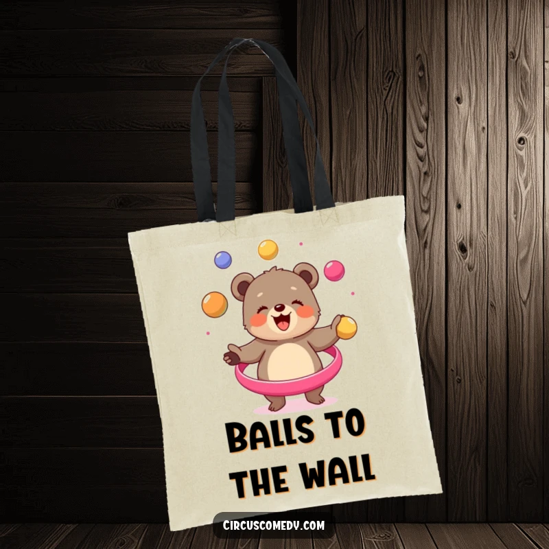Funny bear cub tote bag, skillfully juggling colorful balls in a circus performance, showcasing a joyful character, a practical and amusing accessory.