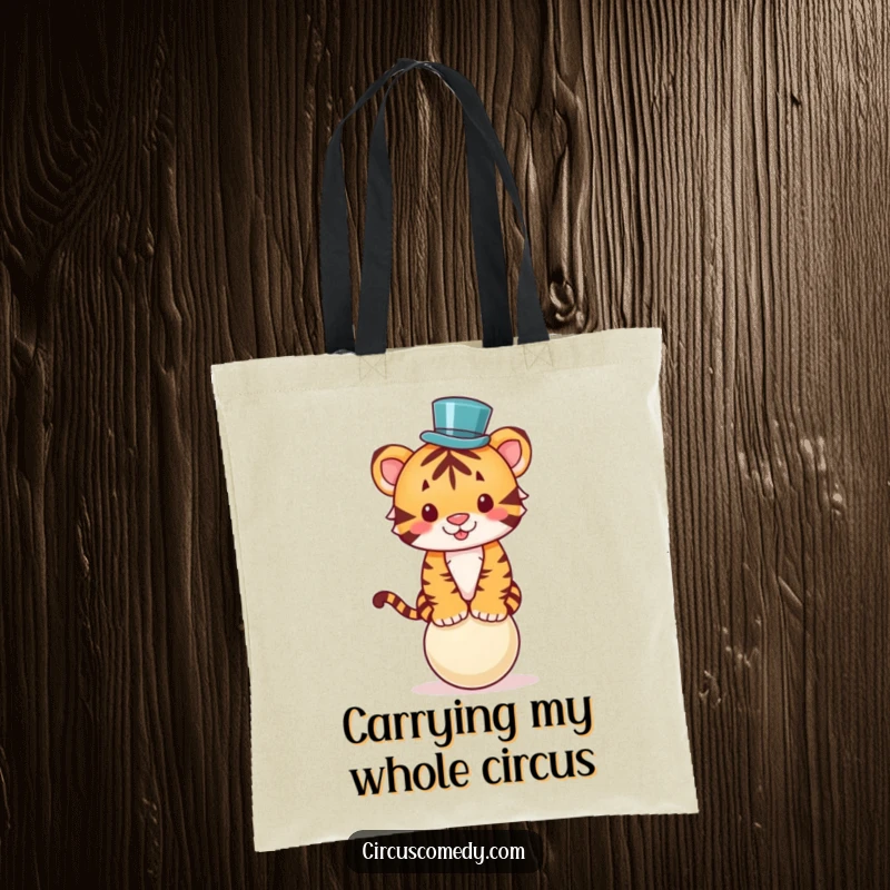 Funny tote bag showcasing a cute tiger in a mini top hat, skillfully balancing on a ball, ready for any adventure.