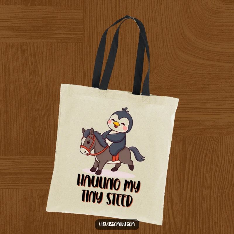 Funny penguin trying to mount a tiny horse, featured on a durable tote bag, ideal for carrying essentials with humor.